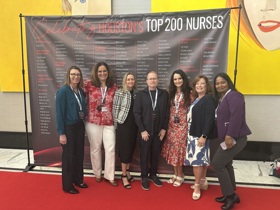 Seven people standing in front of a backdrop celebrating Houston's Top 200 Nurses. From left to right: Allegra Baccinelli, Melissa McDonald, Sarah Hibbs, Roy Trahan, Amirah Abu-Tair, Kimberly Rumsey and Sonia Mathew.